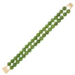 A JADE BEAD BRACELET in 14ct yellow gold, comprising of two rows of polished jade beads, stamped