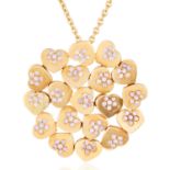 A GEMSET HEART PENDANT in high carat yellow gold, comprising of nineteen hearts set with round cut