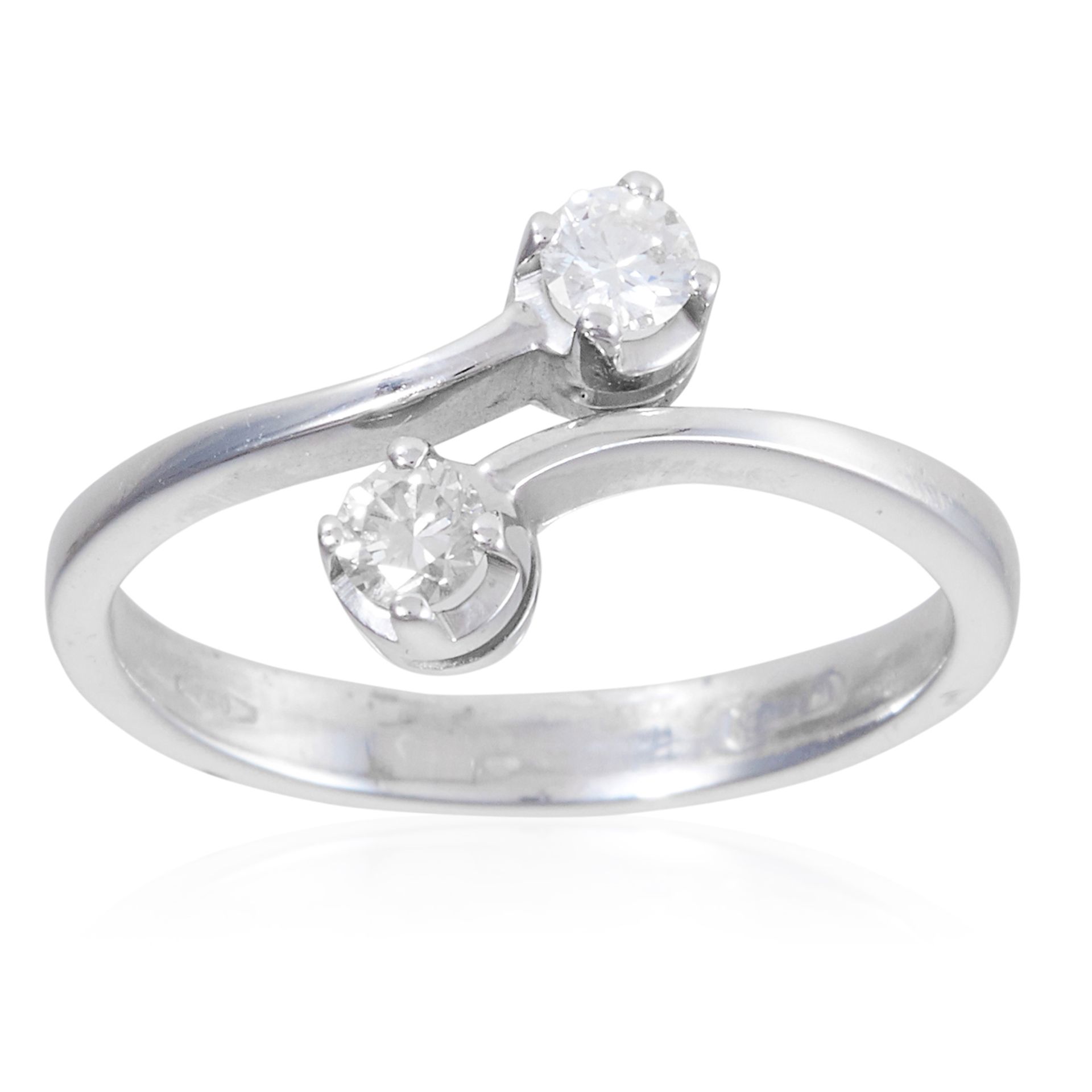 A DIAMOND TOI ET MOI RING, in 18ct white gold, designed as a crossover with 0.2ct of round cut