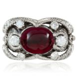 AN ART DECO GARNET AND DIAMOND RING 1940s in platinum or white gold, the oval cabochon garnet