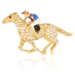 A RUBY, DIAMOND AND ENAMEL NOVELTY BROOCH in yellow gold, depicting a horse and jockey, set with