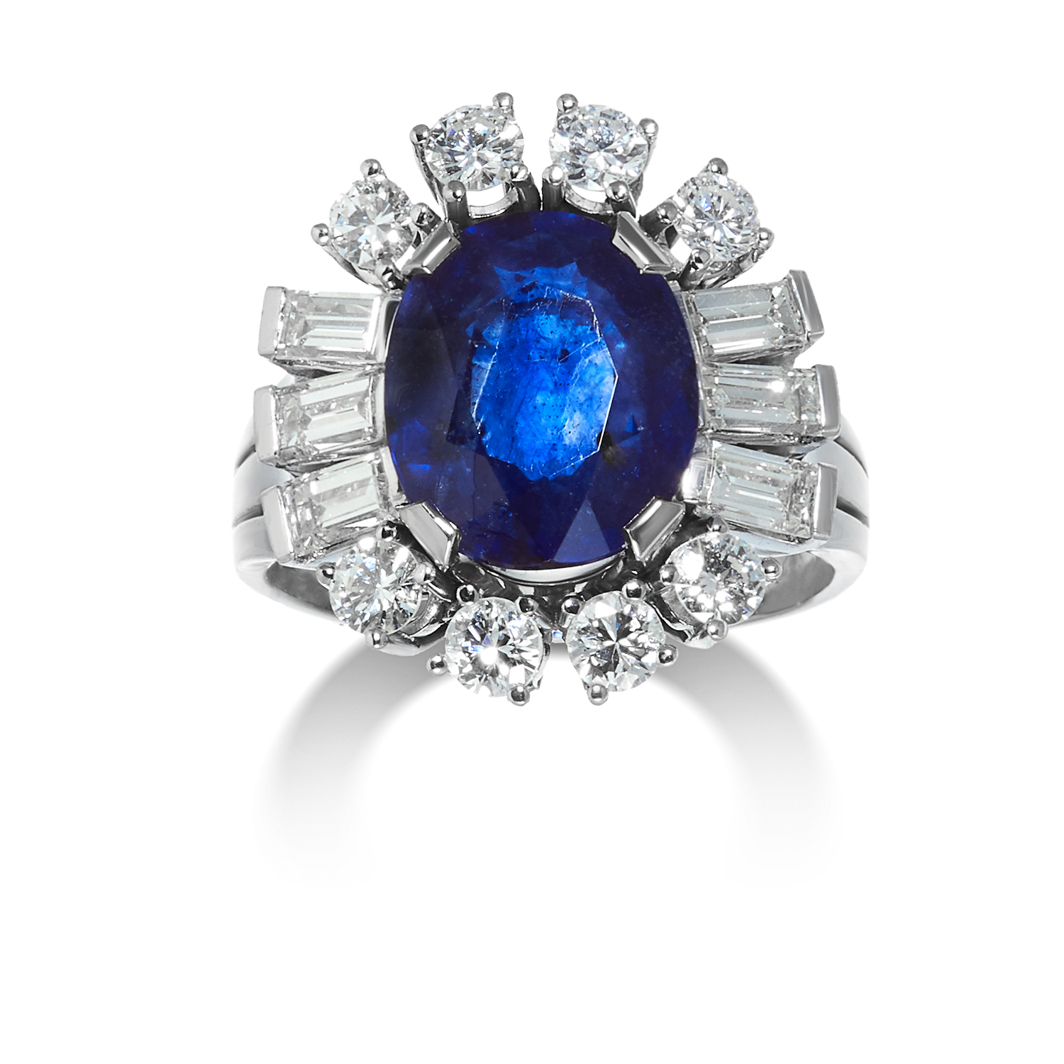 A SAPPHIRE AND DIAMOND CLUSTER RING in 14ct white gold, set with an oval cut sapphire of