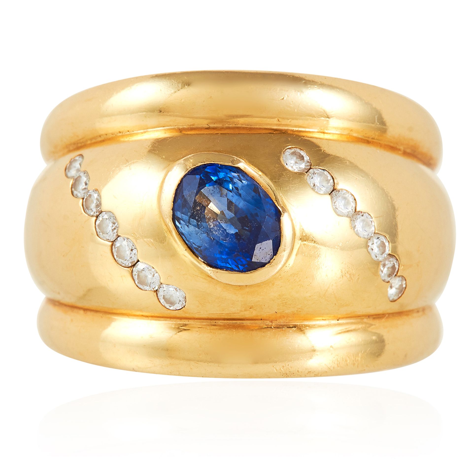 A SAPPHIRE AND DIAMOND DRESS RING in 18ct yellow gold, in thick gold band, set with an oval cut