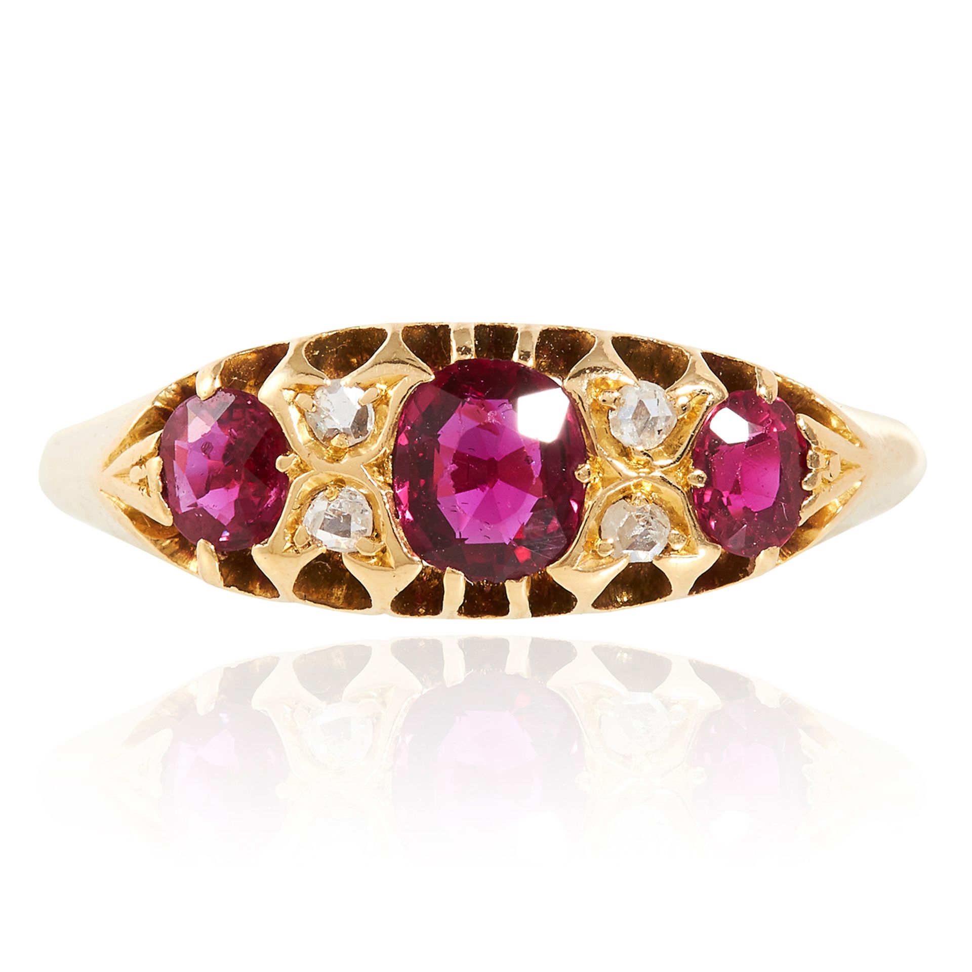 AN ANTIQUE RUBY AND DIAMOND DRESS RING in high carat yellow gold, set with three cushion cut