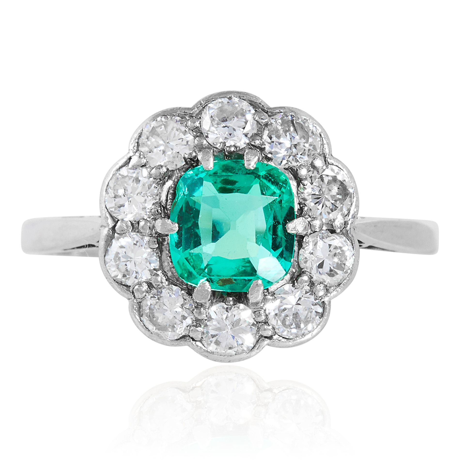 AN EMERALD AND DIAMOND CLUSTER RING in 18ct gold and platinum, set with a cushion cut emerald of