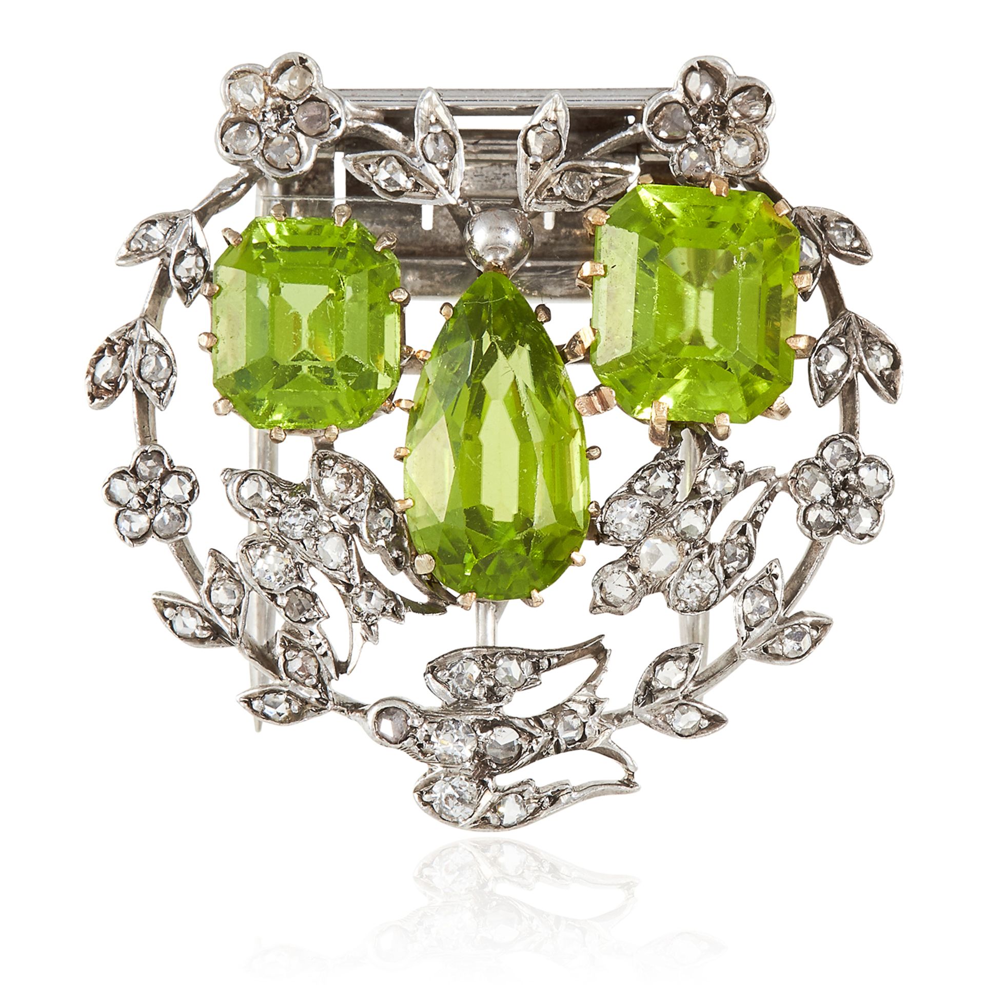 A PAIR OF ANTIQUE PERIDOT AND DIAMOND CLIP BROOCHES in yellow gold and silver, each set with a