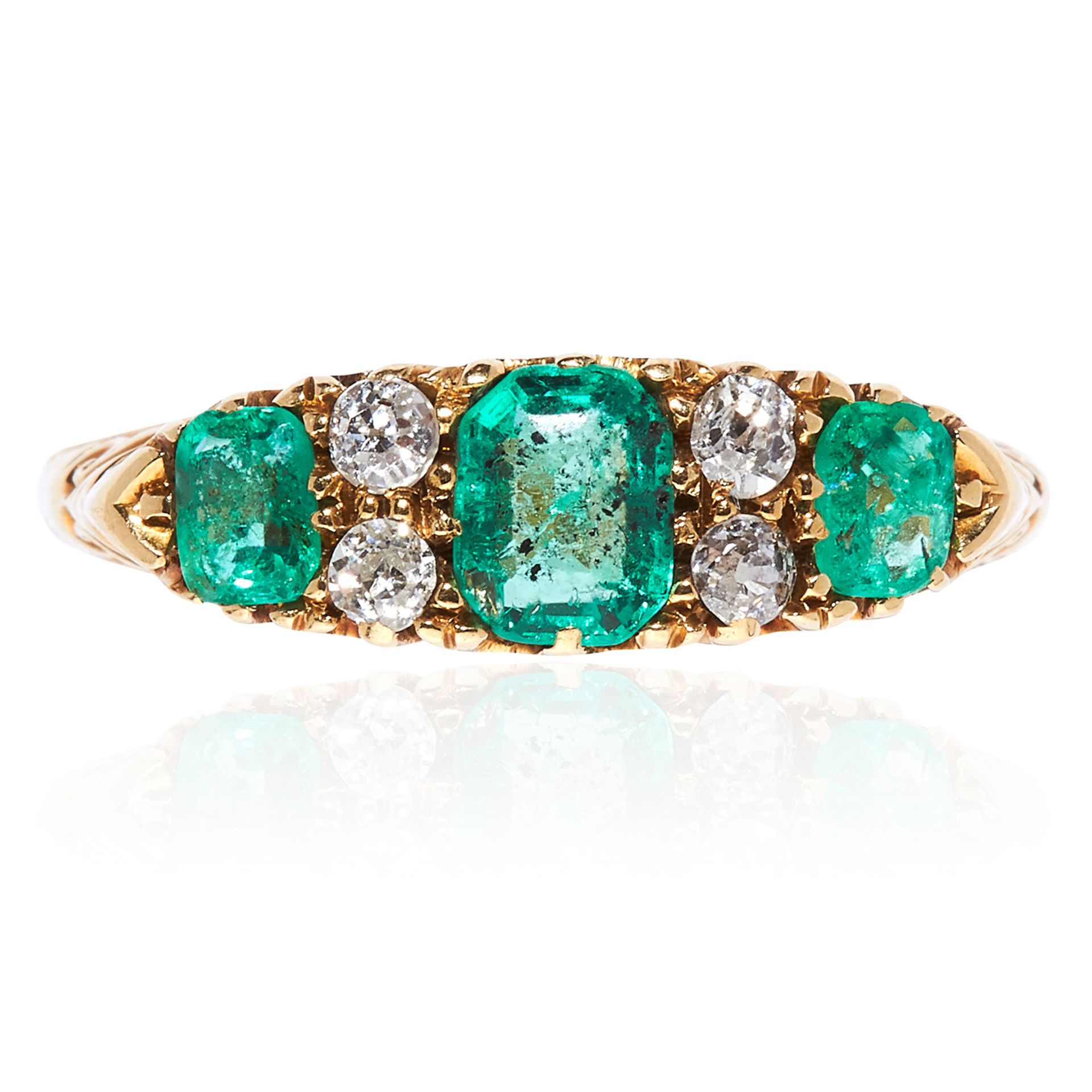 AN ANTIQUE EMERALD AND DIAMOND RING in 18ct yellow gold, set with a trio of step cut emeralds