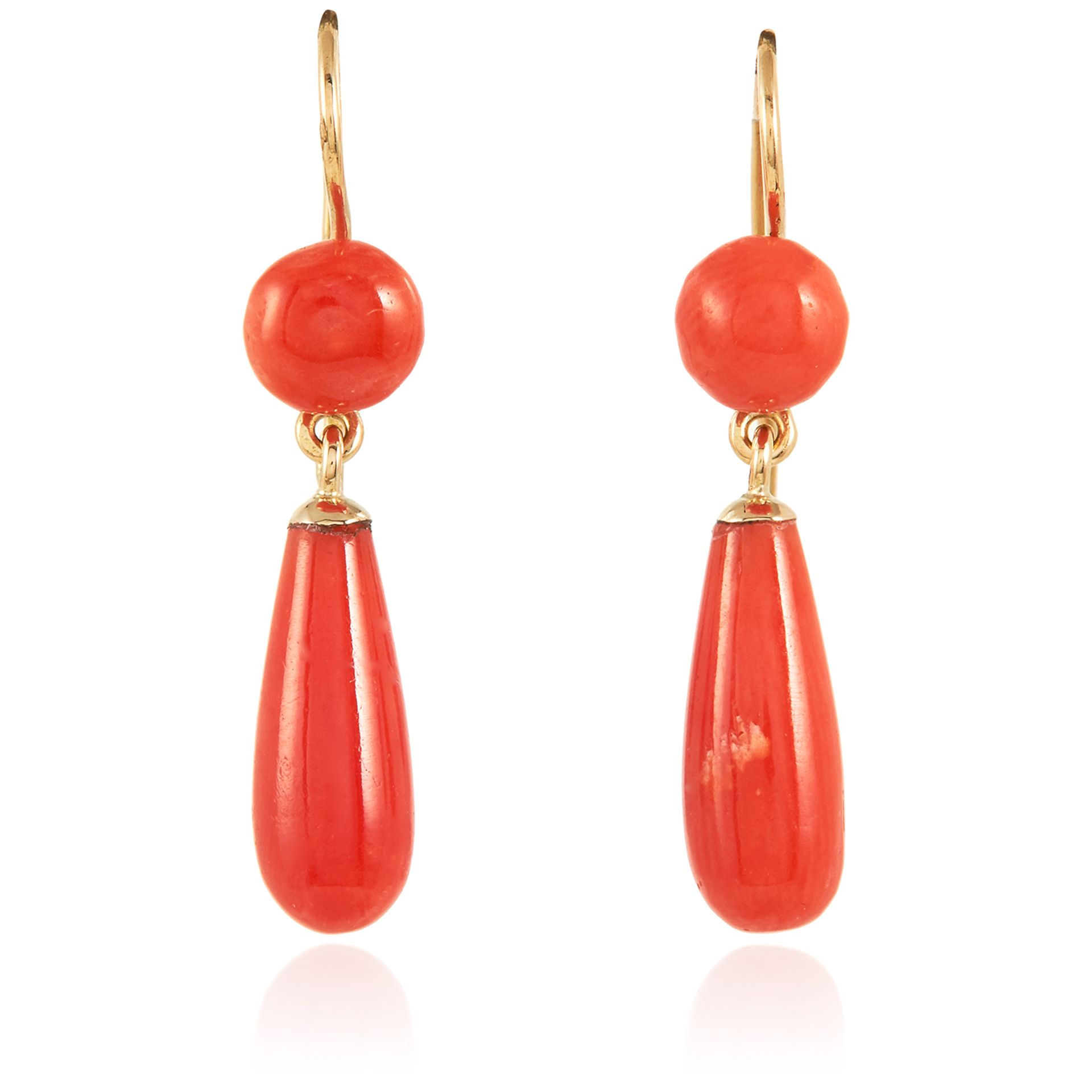 A PAIR OF ANTIQUE CORAL DROP EARRINGS in high carat yellow gold, each suspending a polished coral