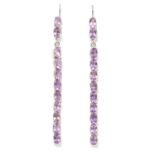 A PAIR OF PURPLE STONE EARRINGS in white metal, each comprising of a line of oval cut purple stones,