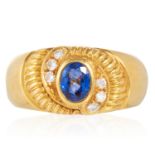 A SAPPHIRE AND DIAMOND DRESS RING in 18ct yellow gold, set with an oval cut Ceylon sapphire and