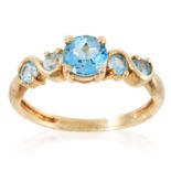 A FIVE STONE TOPAZ RING in yellow gold, set with five round cut topaz, stamped 375, size Q / 8, 2.