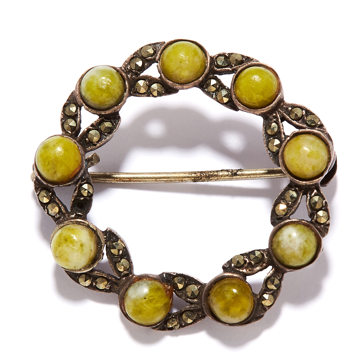 A GREEN HARD STONE AND MARCASITE BROOCH in sterling silver, in circular form, set with marcasite and