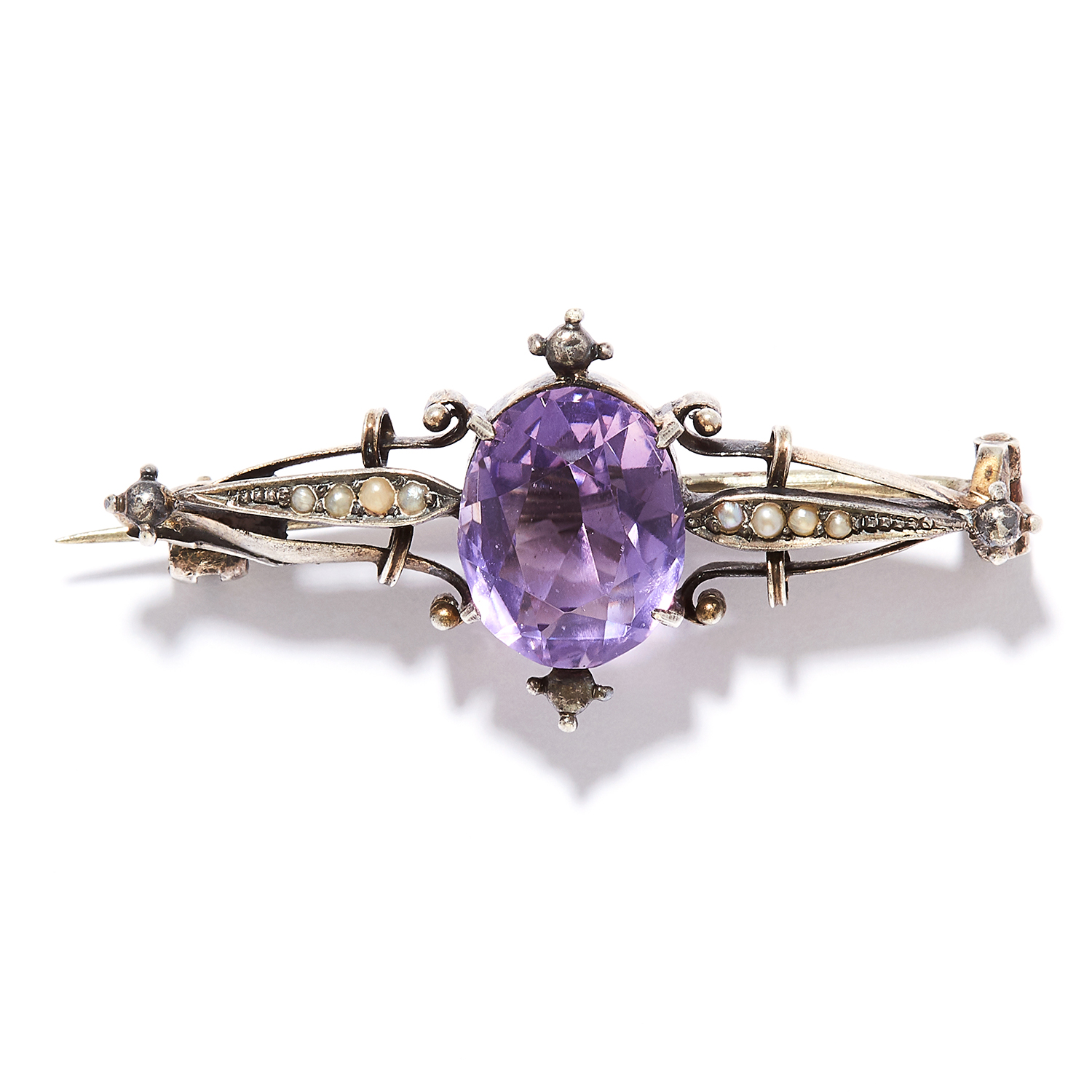 AN AMETHYST AND PEARL BROOCH in sterling silver, set with an oval cut amethyst between eight seed