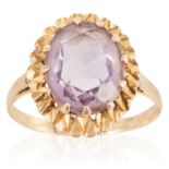 AN AMETHYST DRESS RING in yellow gold, set with an oval cut amethyst, stamped 9C, size R / 8.5, 4.