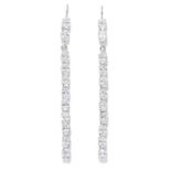 A PAIR OF WHITE STONE EARRINGS in white metal, each comprising of a line of oval cut white stones,