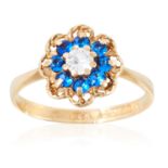 A GEMSET CLUSTER RING in yellow gold, comprising of round cut clear and blue gemstones in cluster