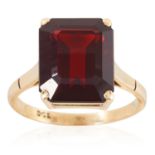 A GARNET DRESS RING in yellow gold, comprising of an emerald cut garnet, stamped 9CT, size L / 6,