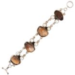 A SMOKEY QUARTZ AND PEARL BRACELET, INDIAN in sterling silver, set with four faceted smokey quartz