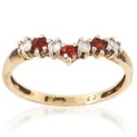 A GEMSET RING in yellow gold, set with alternating round cut red and white gemstones, unmarked, size