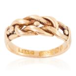 A GOLD KEEPER RING in yellow gold, depicting intertwined ropes, British hallmarks, size L / 5.5, 3.