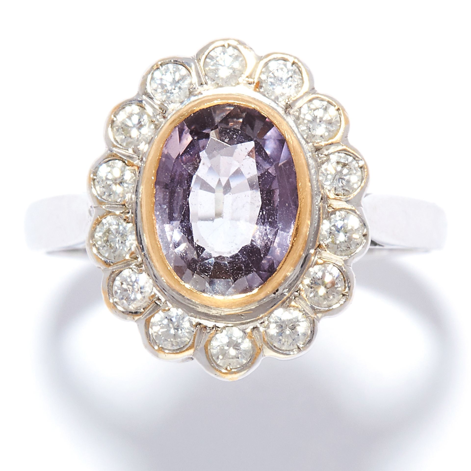 PURPLE SAPPHIRE AND DIAMOND CLUSTER RING in 18ct white gold, set with an oval cut purple sapphire of