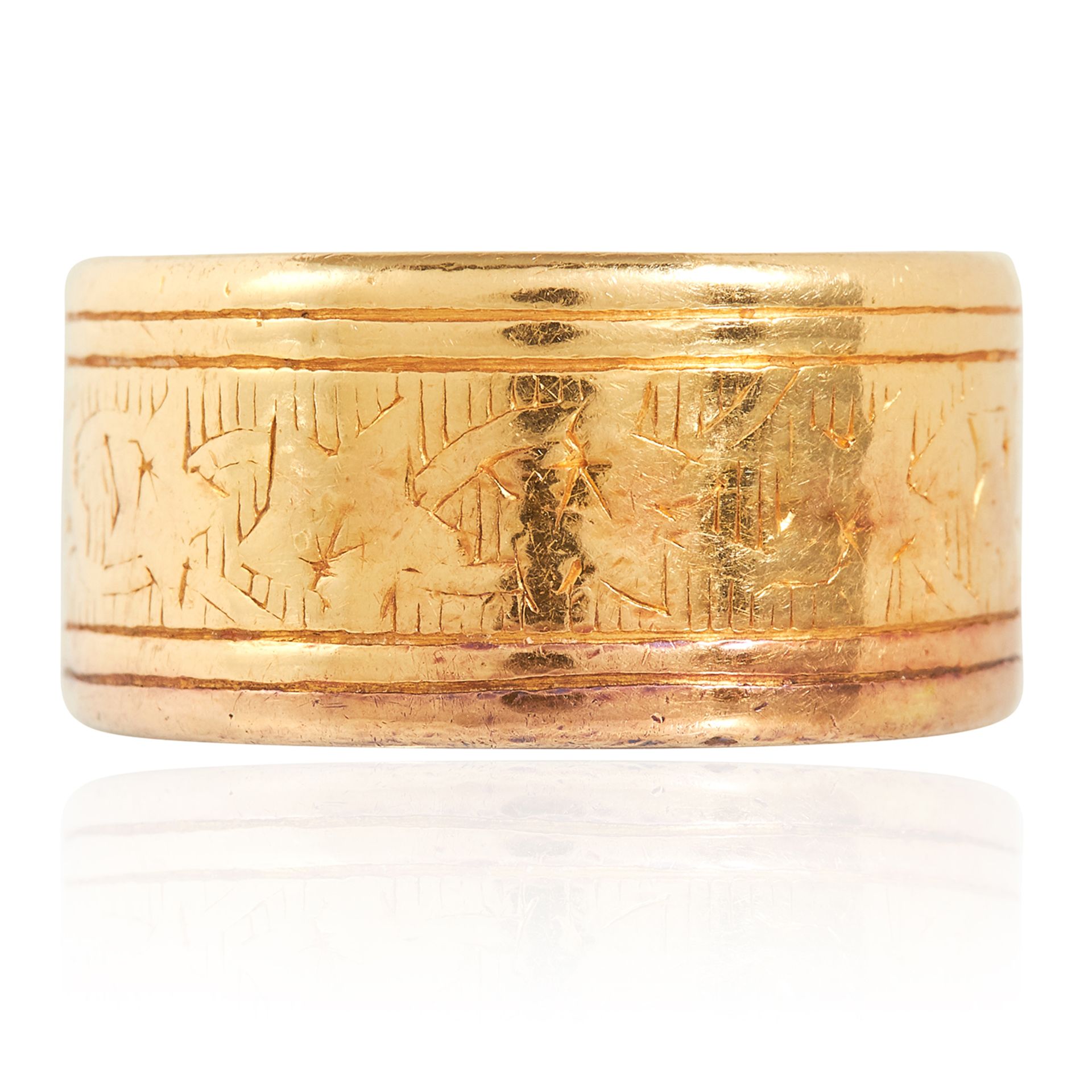 A 22CT YELLOW GOLD BAND RING, 1960 the broad band with engraved decoration, full British