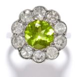 PERIDOT AND DIAMOND CLUSTER RING in platinum or white gold, the round cut peridot encircled by