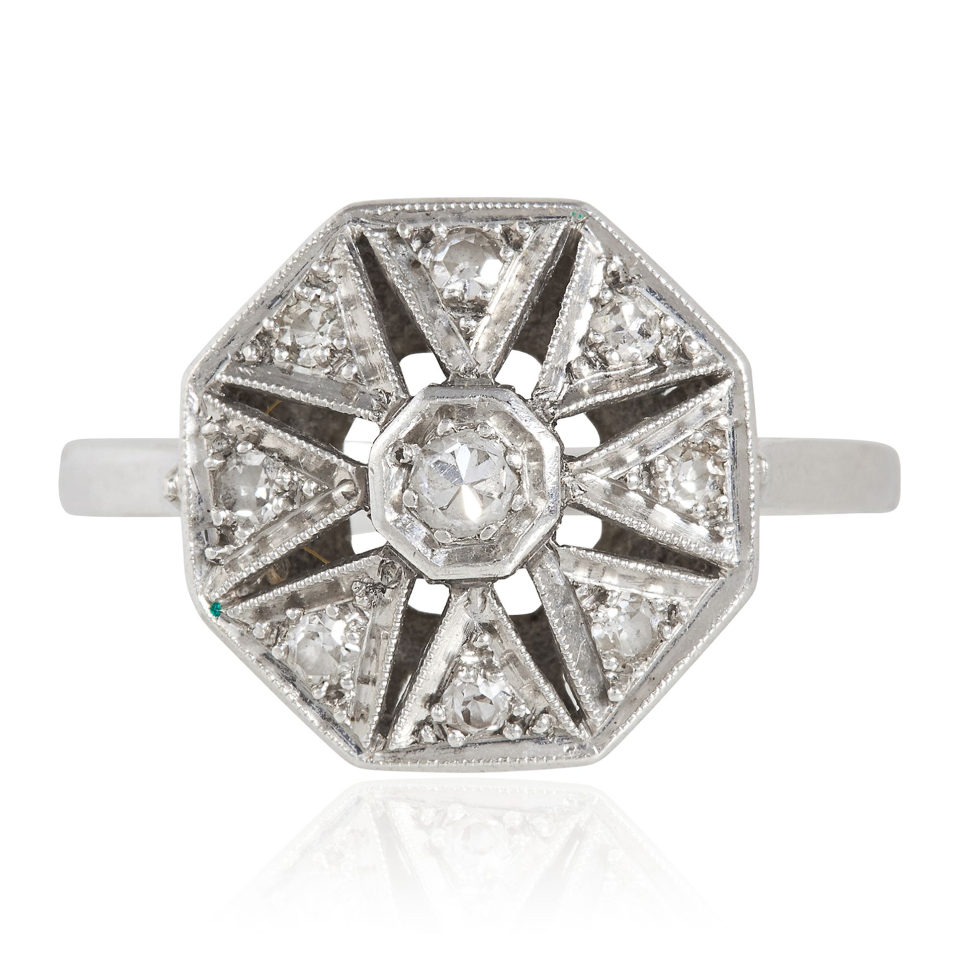 AN ART DECO DIAMOND RING in platinum, the octagonal face with openwork star motif, jewelled with