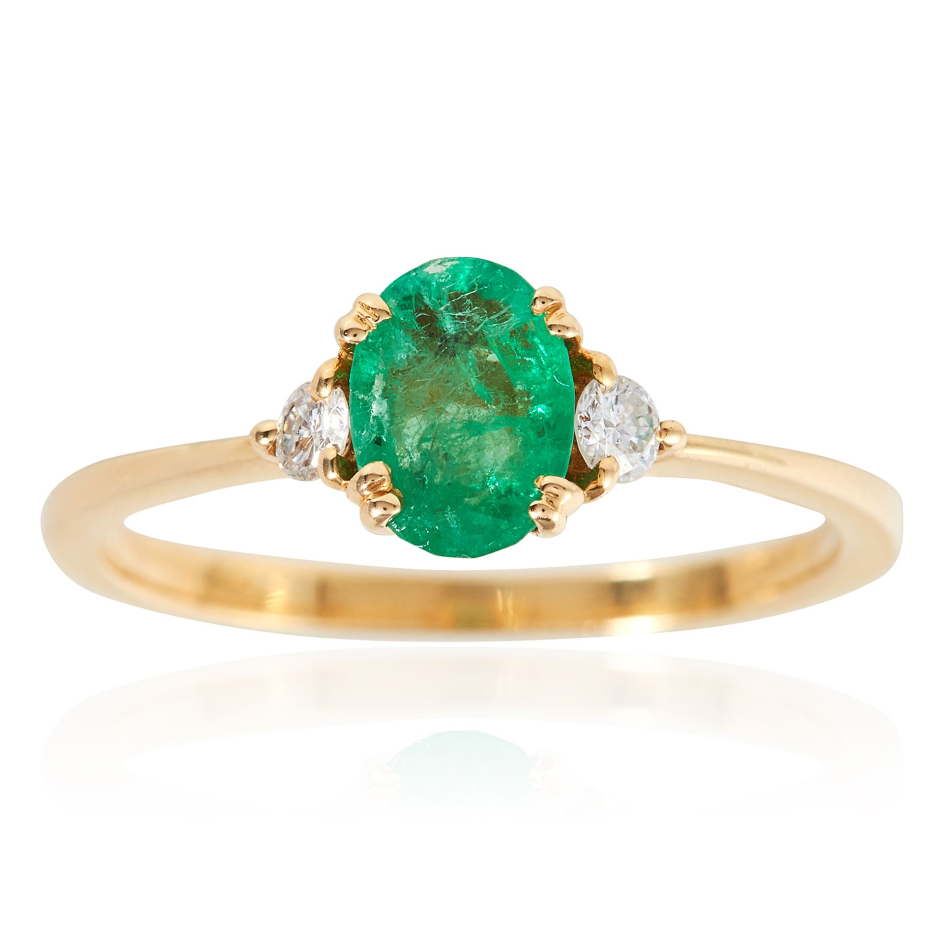 AN EMERALD AND DIAMOND DRESS RING in 18ct yellow gold, the oval cut emerald between round cut