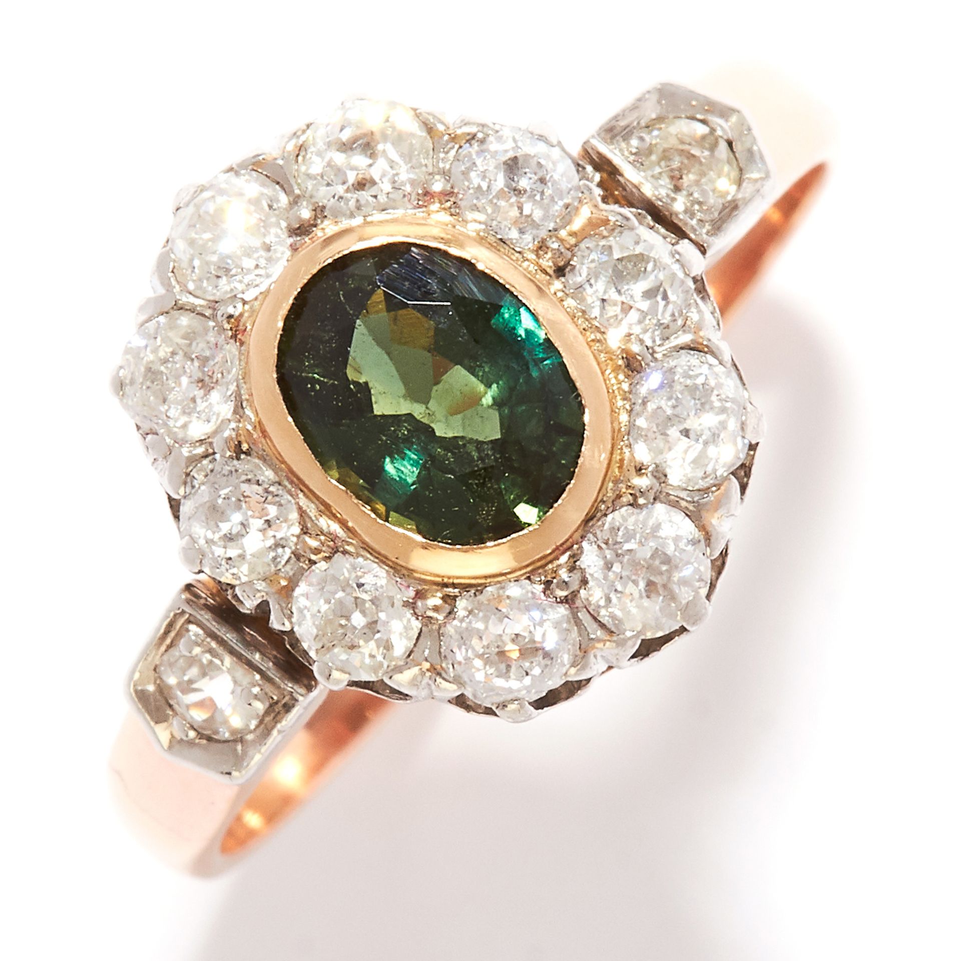 GREEN SAPPHIRE AND DIAMOND CLUSTER RING in yellow gold, set with an oval cut green sapphire in a