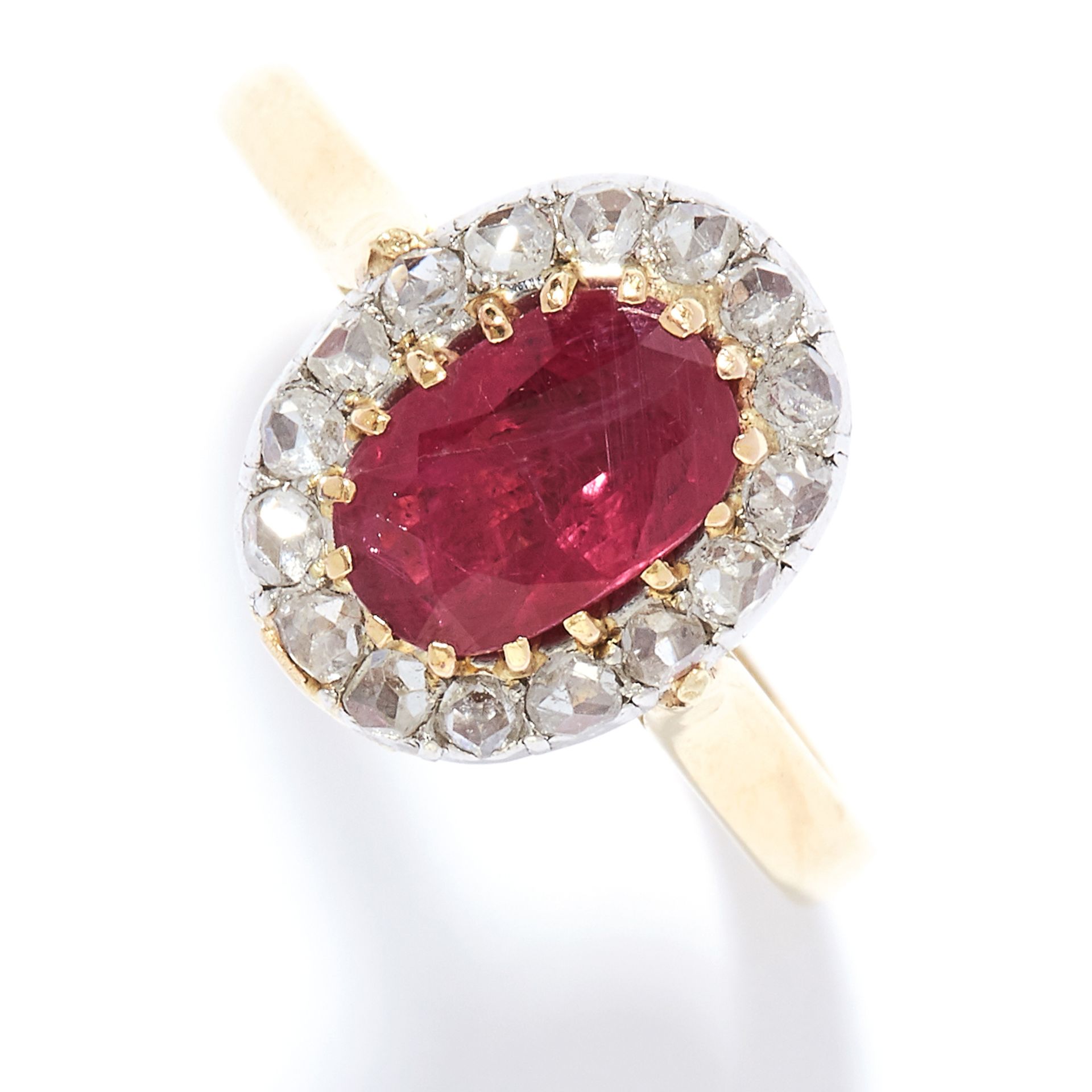 RUBY AND DIAMOND CLUSTER RING in 18ct white gold, the oval cut ruby encircled by rose cut