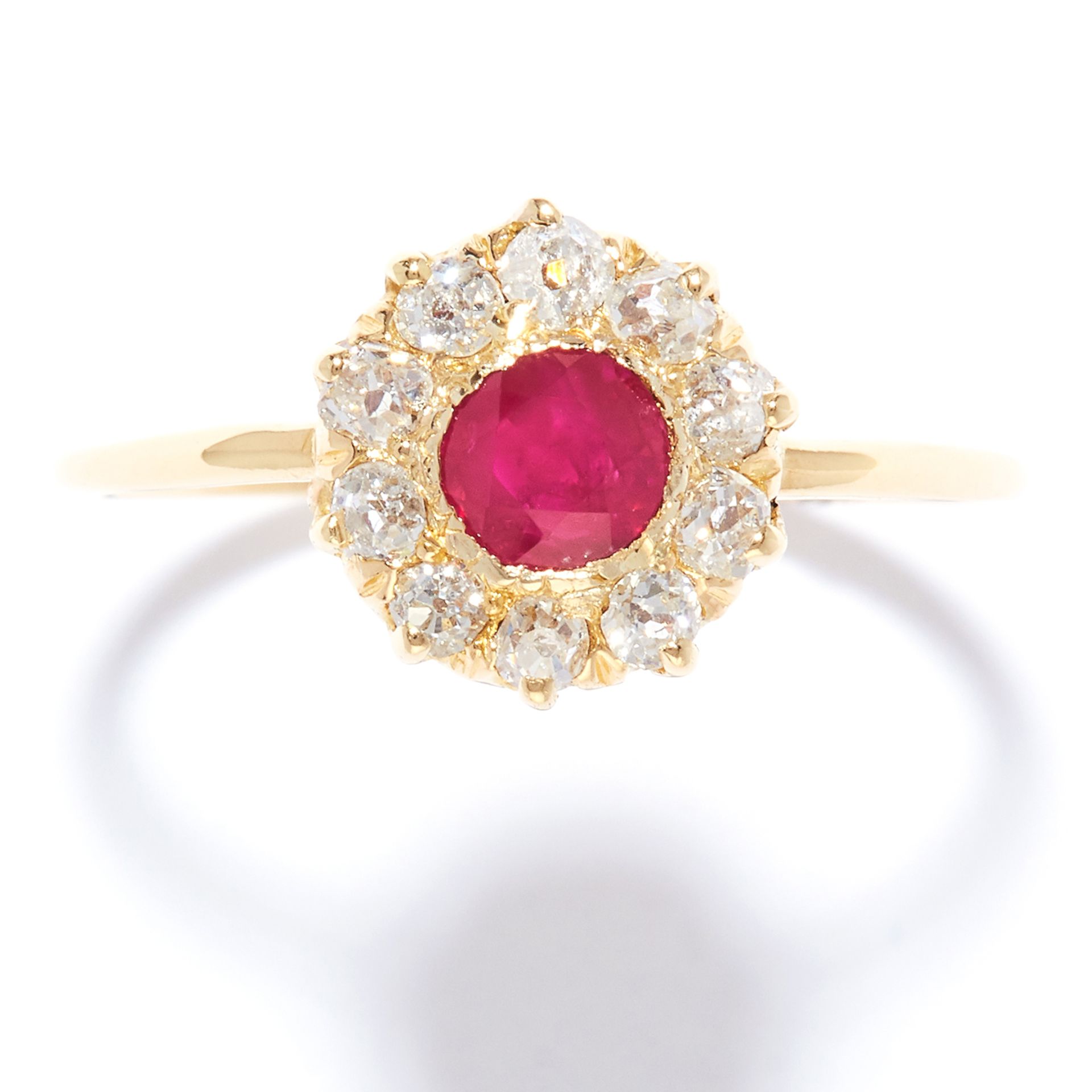 ANTIQUE RUBY AND DIAMOND CLUSTER RING in high carat yellow gold, set with a round cut ruby in a