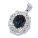 SAPPHIRE AND DIAMOND PENDANT in white gold or platinum, set with a faceted sapphire, in a cluster of