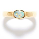 OPAL DRESS RING, 1970s in 18ct yellow gold, the oval cabochon opal within a stylised band, stamped