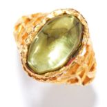 ANTIQUE PERIDOT RING in high carat yellow gold, set with a cabochon peridot in open scrolling