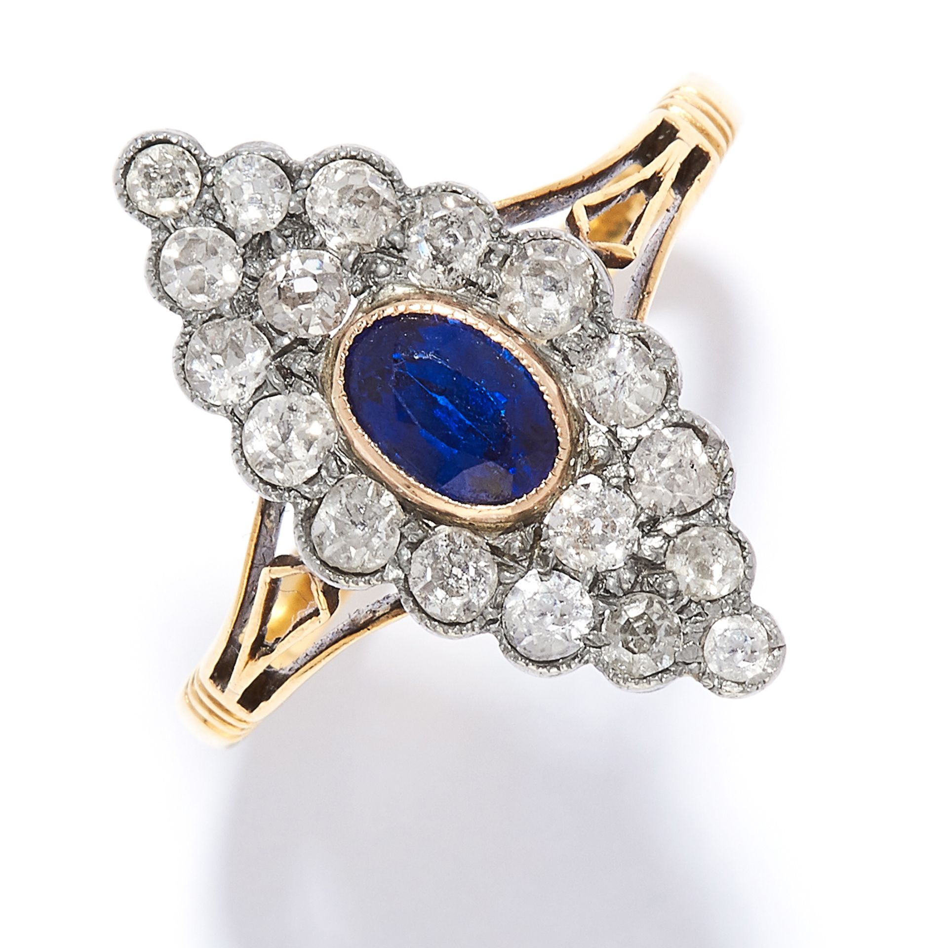 SAPPHIRE AND DIAMOND RING in high carat yellow gold, the marquise face is set with an oval cut