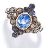 SAPPHIRE AND DIAMOND CLUSTER RING in high carat yellow gold, set with an oval cut sapphire in a