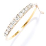 ANTIQUE 10.00 CARAT DIAMOND BANGLE in high carat yellow gold, set with a row of old cut diamonds