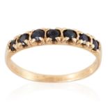 A SAPPHIRE ETERNITY RING in yellow gold, set with seven round cut sapphires, marked indistinctly,