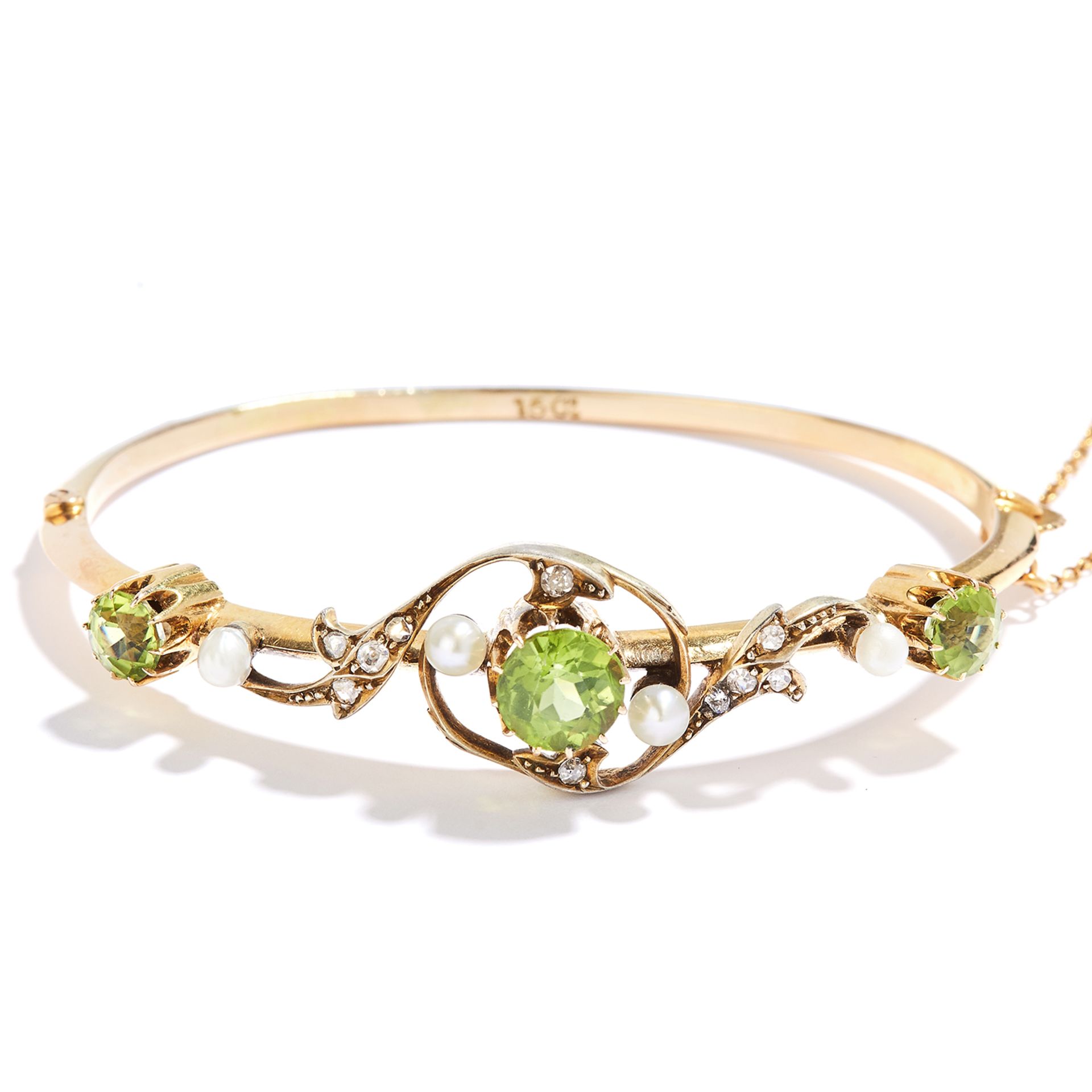 ANTIQUE PERIDOT, PEARL AND DIAMOND BANGLE in 15ct yellow gold, comprising of three oval cut peridot,
