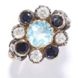 AQUAMARINE, SAPPHIRE AND DIAMOND CLUSTER RING in yellow gold, set with a round cut aquamarine in a