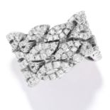 DIAMOND DRESS RING in white gold or platinum, in articulated design, set with round cut diamonds,