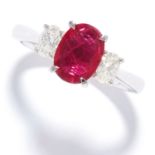 RUBY AND DIAMOND THREE STONE RING in 18ct white gold, set with an oval cut ruby of approximately 1.