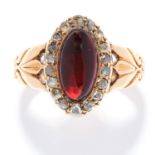 ANTIQUE GARNET AND DIAMOND RING in 18ct yellow gold, set with a cabochon garnet in a cluster of rose