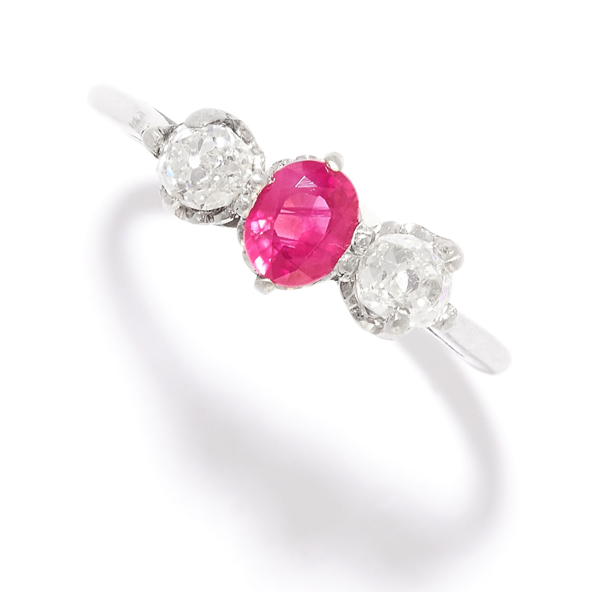 RUBY AND DIAMOND THREE STONE RING in gold or platinum, set with an oval cut ruby between two old cut