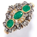 EMERALD AND DIAMOND RING in high carat yellow gold and silver, the trio of oval cut emeralds