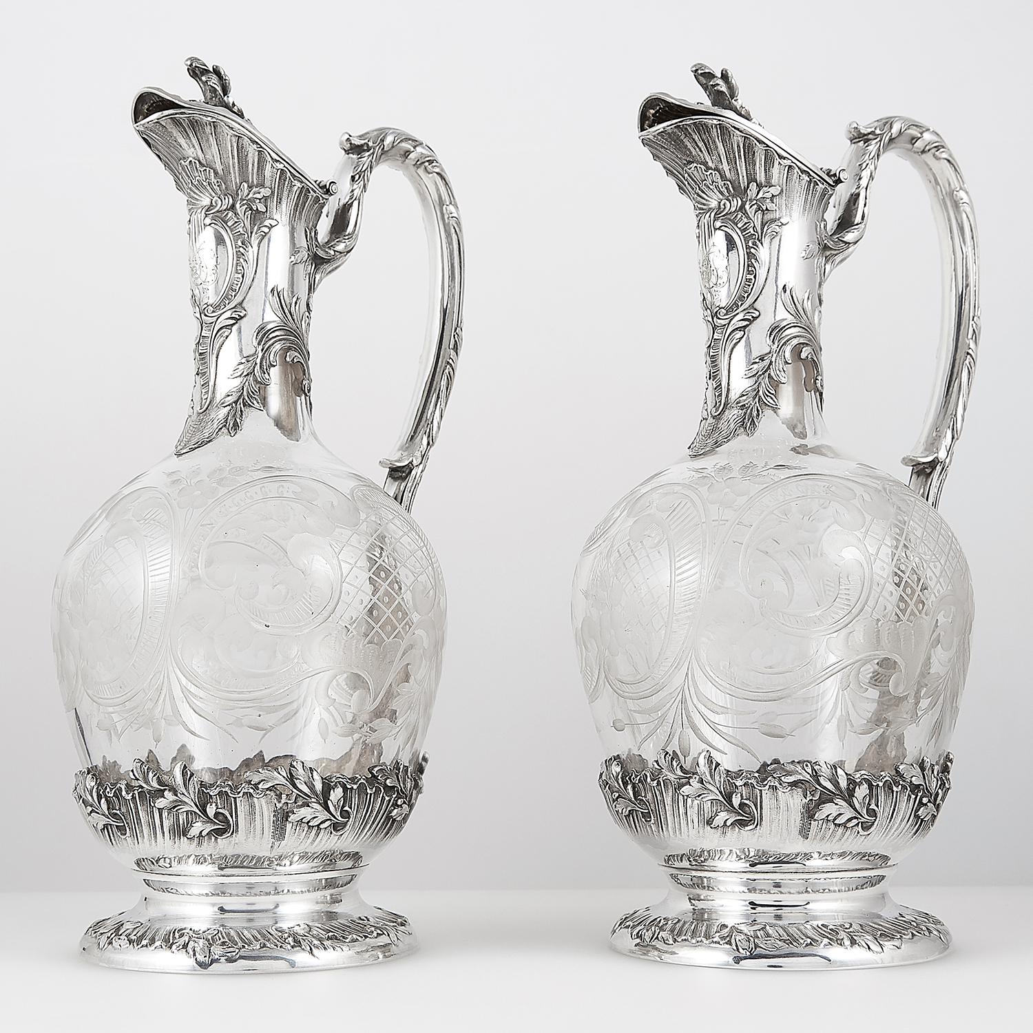 PAIR OF ANTIQUE FRENCH SILVER MOUNTED CUT GLASS CLARET JUGS, TETARD FRERES CIRCA 1890 the bulbous