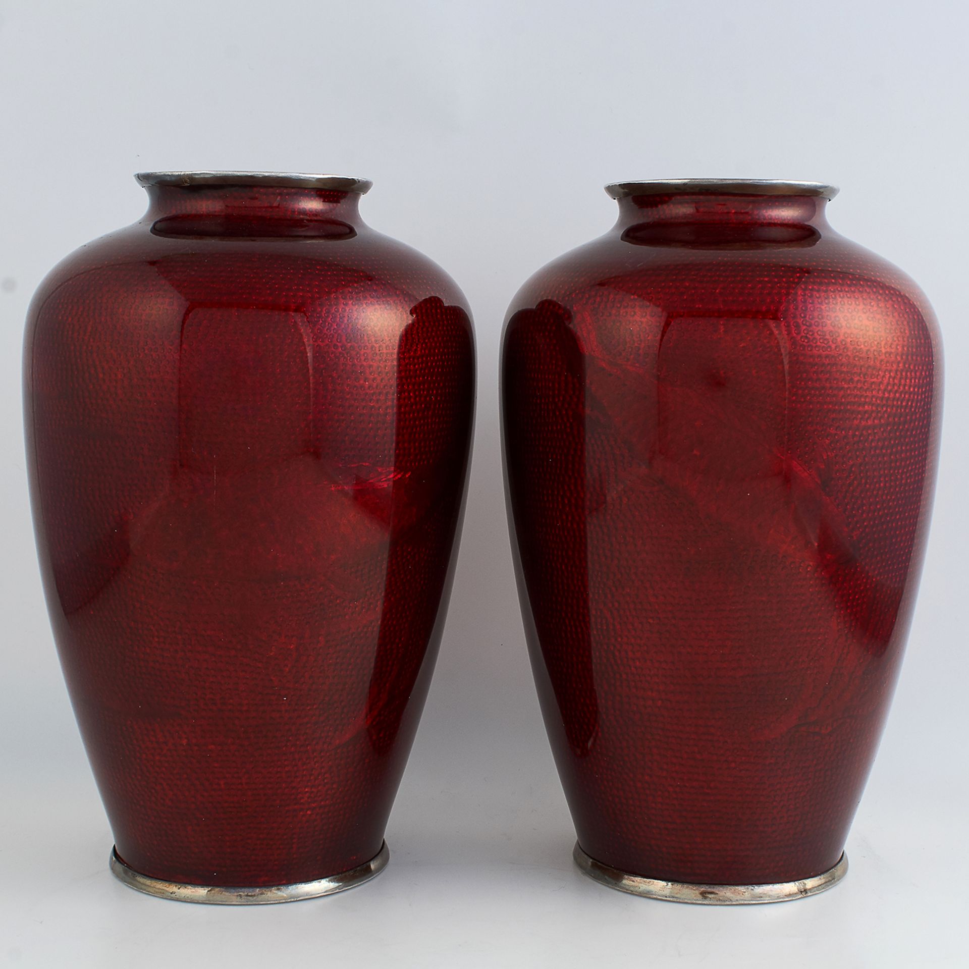 PAIR OF ANTIQUE SILVER AND ENAMEL VASES CIRCA 1920 the tapering rounded bodies decorated in red
