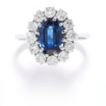 SAPPHIRE AND DIAMOND CLUSTER RING in 18ct white gold, set with an oval cut sapphire in a cluster