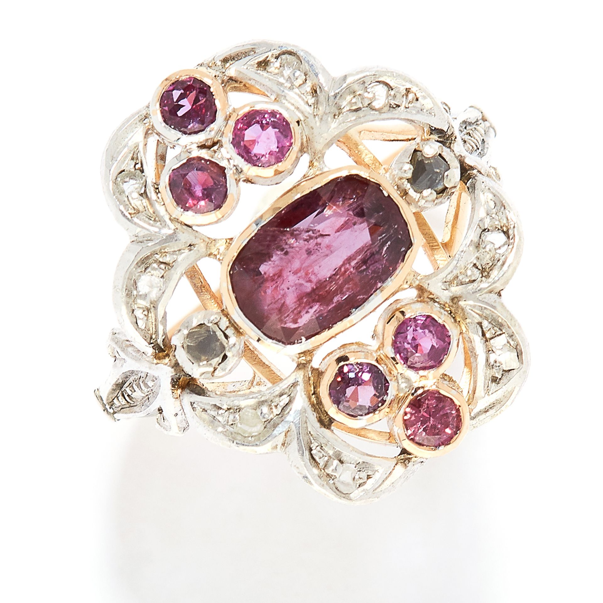 GARNET AND DIAMOND RING in yellow gold, in open scrolling design set with oval and round cut garnets